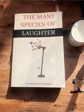 The Many Species of Laughter Paperback — White Cover with Black and Red Text
